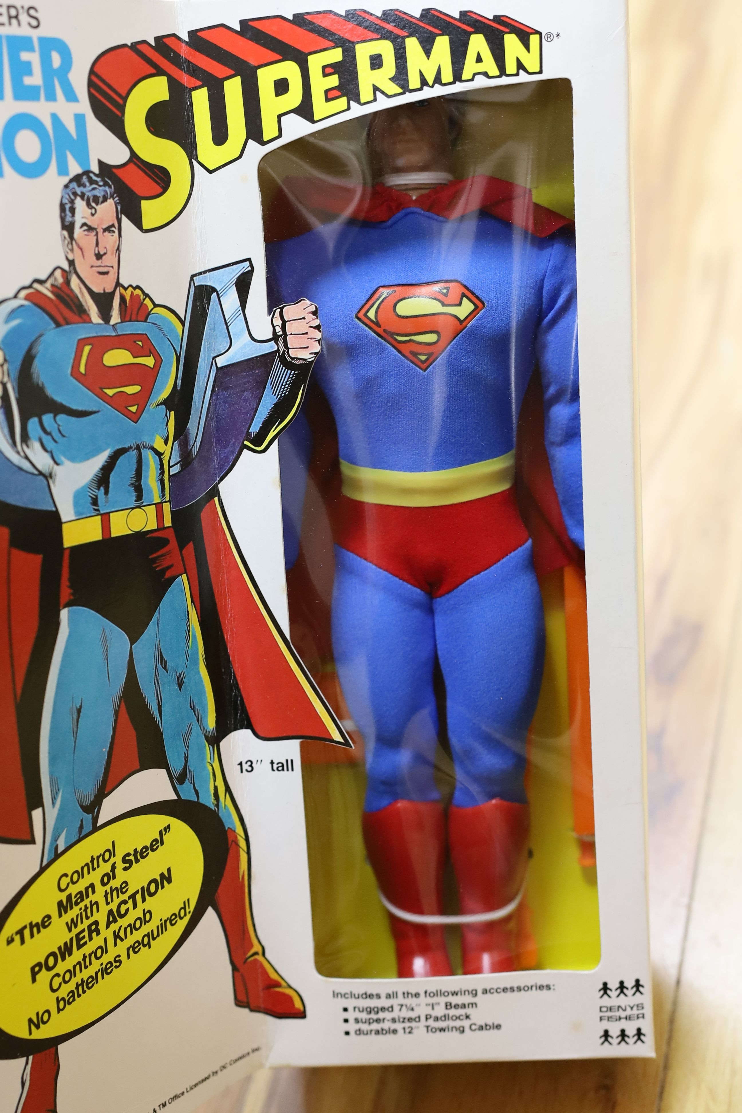 A Denys Fisher Superman, rare in original box, another unboxed, a Unigate milk float with bottles, and a boxed Evel Knievel Stunt Cycle